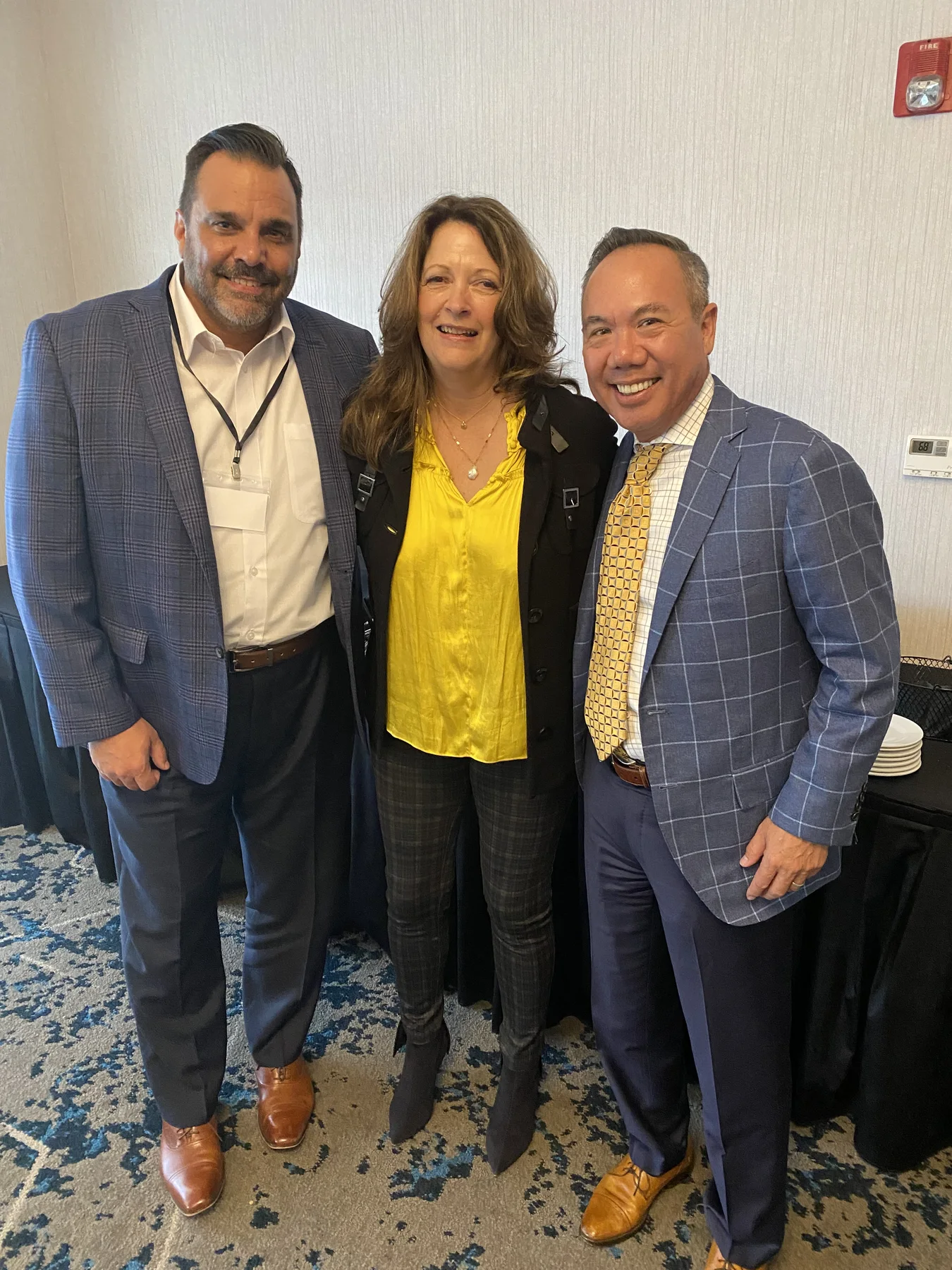 Dr. Michael Njo standing with two dental industry colleagues at a professional event